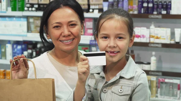 Mãe e filha fizeram compras na farmácia com um cartão de crédito — Fotografia de Stock