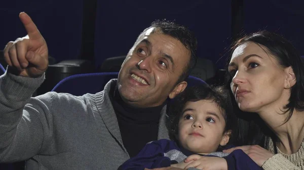 Close up of a happy loving family watching movies at the cinema — Stock Photo, Image