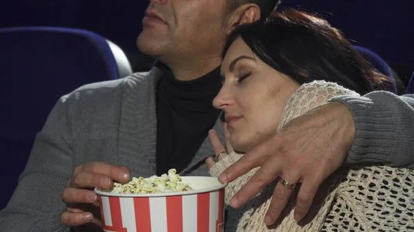 Mature woman sleeping on the shoulder of her husband at the cinema — Stock Photo, Image