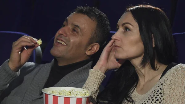 Close up of a mature couple watching a movie together at the cinema — Stock Photo, Image