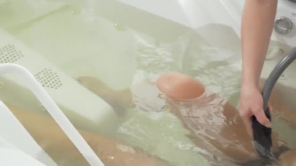 Sliding cropped shot of a gorgeous woman enjoying hydromassage at spa center — Stock Video