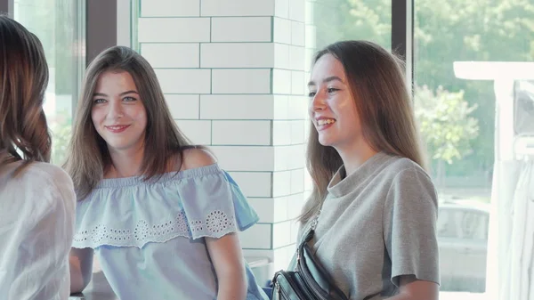 Três lindas jovens mulheres conversando tomando café juntas no café — Fotografia de Stock