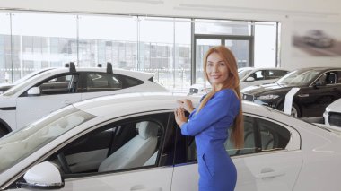 Muhteşem uzun saçlı kadın bayilik yeni pahalı otomobil okşayarak