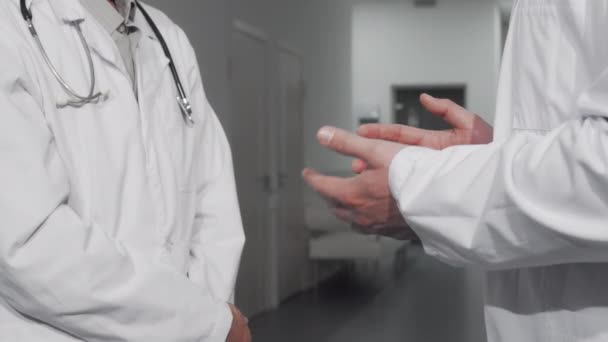 Nerozpoznatelní lékaři si potřásají rukou v nemocnici — Stock video
