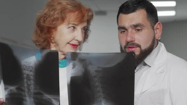 İki doktor hastalarının röntgen taramalarını tartışıyor. — Stok fotoğraf
