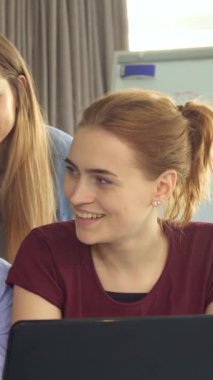 Üç kadın ve iki erkekten oluşan canlı bir grup, hepsi de genç profesyoneller, şık bir ofis ortamında parlak bir dizüstü bilgisayarın etrafında toplanırken neşe içinde başparmaklarını gösteriyorlar. Işıl ışıl gülüşleri ve gevşemiş titreşimleri pozitif bir takım ruhu yayıyor.