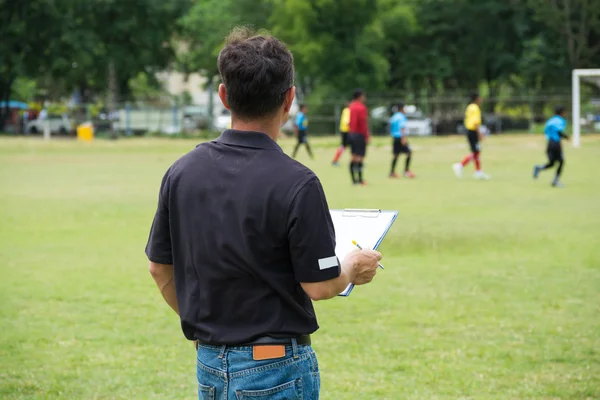 Strategy Male Coach or Team Manager drawing Plan or Pattern of Playing Soccer or Football as Diagram on Chart board as Strategy or Teamwork Coaching concept