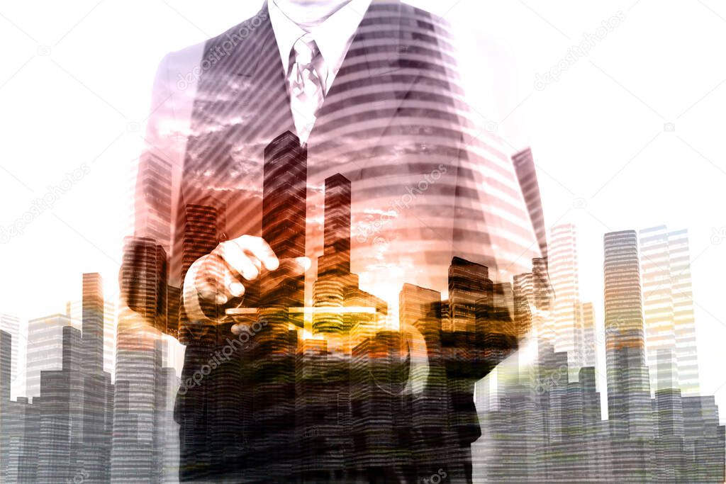 Double Exposure of Businessman hold Digital Wireless Table with City Building and Skyscraper as Concept of Real Estate or Technology business administration.