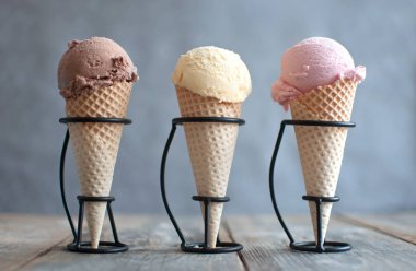 Chocolate, strawberry and vanilla ice cream cones clipart