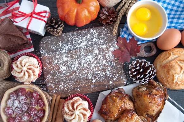 Thanksgiving meal ingredients around a wooden cutting board