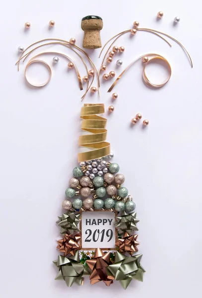 Open champagne bottle made from decorations including baubles and ribbon