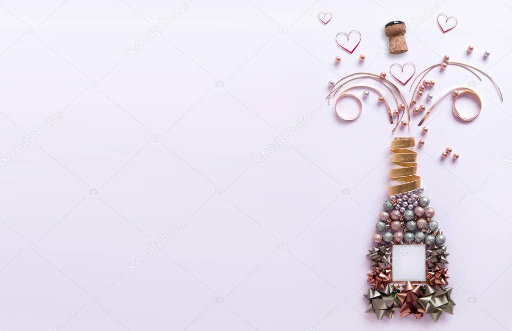 Decorations and heart shape ribbons exploding from a bottle of champagne with background space
