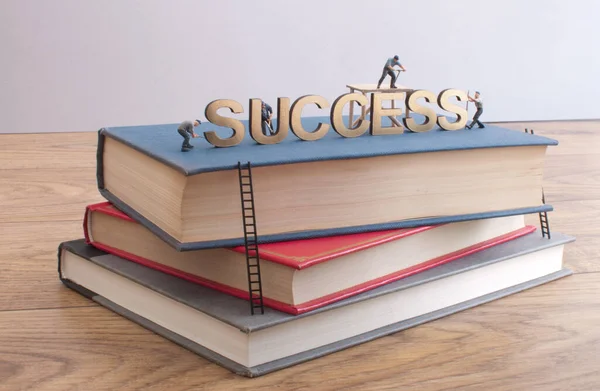 Miniature Construction Builders Working Golden Heading Succcess Top Stack Books — Stock Photo, Image