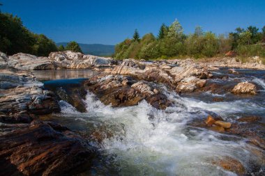 Mountain River in the Carpathians, stones and splashing in the foreground