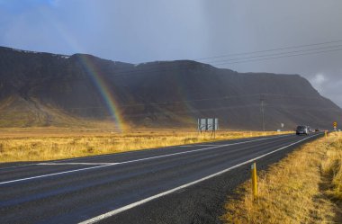 Güney İzlanda - 10th Ekim 2018: Bir güzel gökkuşağı ve İzlanda'daki otoyolu.
