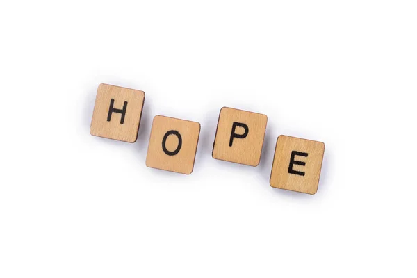 Das Wort Hope Buchstabiert Mit Hölzernen Buchstabenkacheln Über Einem Schlichten — Stockfoto