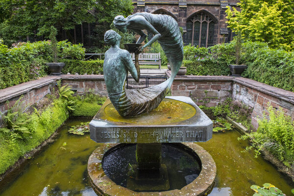 Chester, UK - July 31st 2018: The beautiful Water of Life sculpture in the cloister garth garden at Chester Cathedral in the historic city of Chester in Cheshire, UK. 