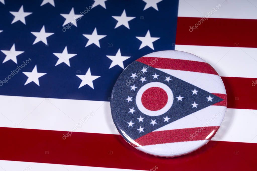 London, UK - November 15th 2018: The symbol of the State of Ohio, pictured over the flag of the United States of America.