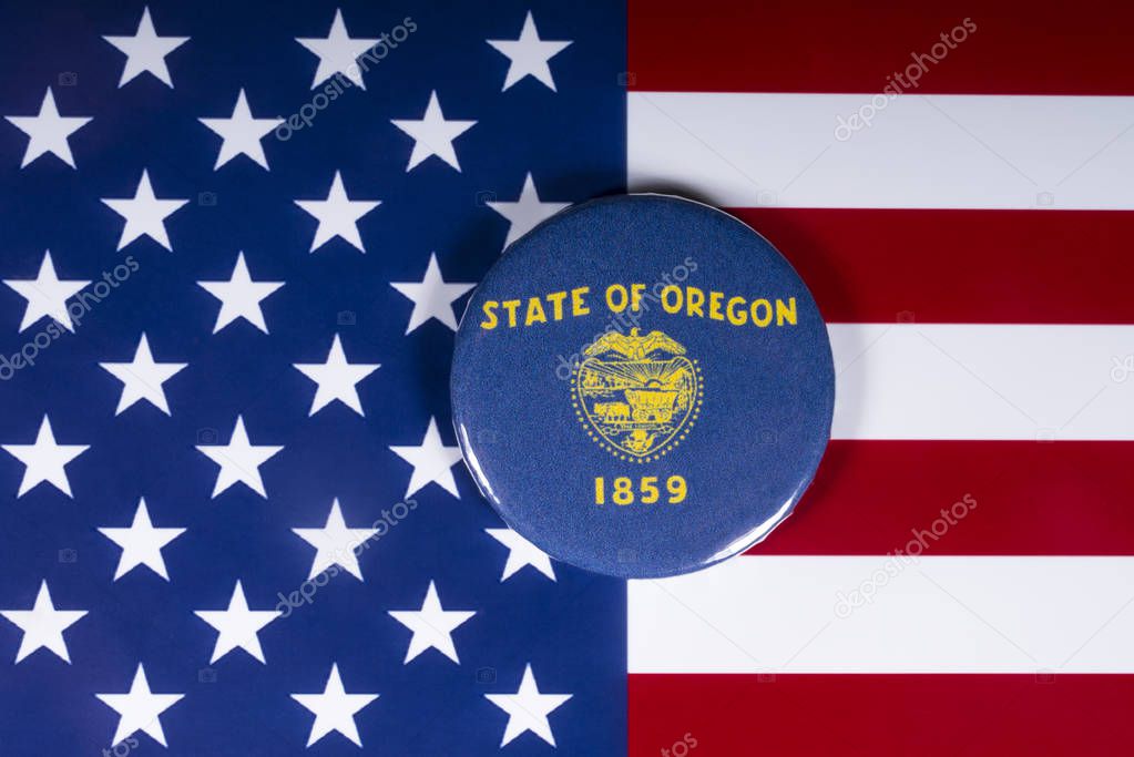 London, UK - November 20th 2018: The symbol of the State of Oregon, pictured over the flag of the United States of America.