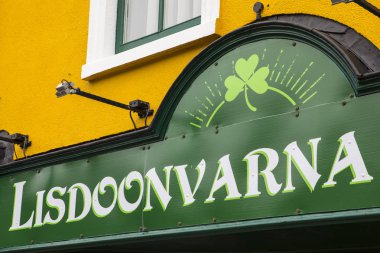 Lisdoonvarna, Republic of Ireland - August 19th 2018: The place name Lisdoonvarna on the exterior of a shop in the spa town of Lisdoonvarna in Ireland.  clipart