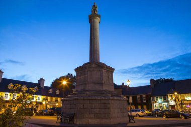 Westport, Republic of Ireland - August 20th 2018: A view of the Octagon with its column and the statue of St. Patrick, in the town of Westport, in County Mayo Ireland. clipart