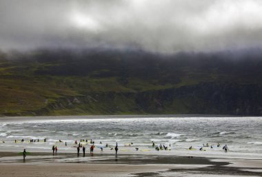 County Mayo, Ireland - 21 Ağustos 2018: Sörfçü Achill Adası İrlanda'güzel salma sahilde. 