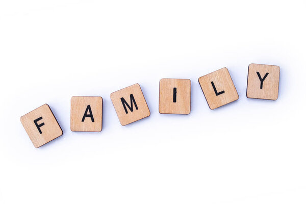 The word FAMILY, spelt with wooden letter tiles.
