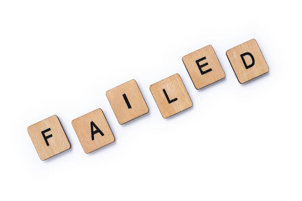The word FAILED, spelt with wooden letter tiles over a white background.