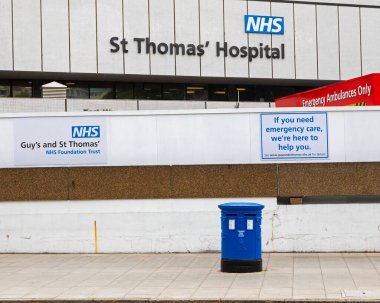Londra, İngiltere - 17 Haziran 2020: Londra 'daki St. Thomas Hastanesi' nin dış cephesi, dışarıdaki mavi posta kutusu Coronavirus salgını sırasında NHS 'i desteklemek için maviye boyanmış..