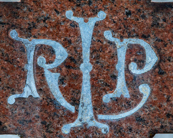 RIP, the abbreviation for Rest in Peace inscribed on a headstone in a graveyard or cemetery.