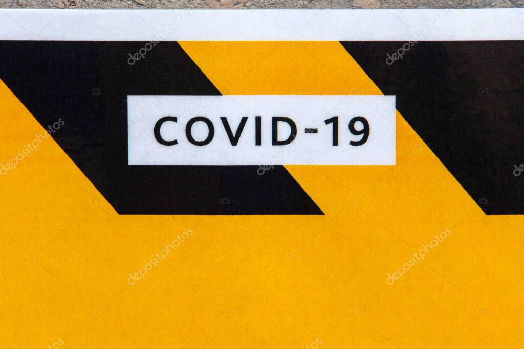 Close-up of COVID-19 on a sign in London, UK.