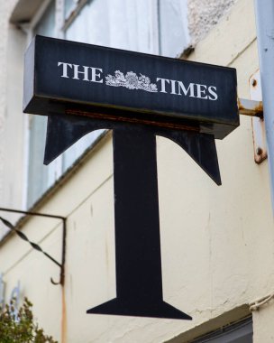 Beaumaris, Wales - September 1st 2020: A vintage sign promoting The Times newspaper, on the exterior of a shop in Beaumaris, Wales. clipart