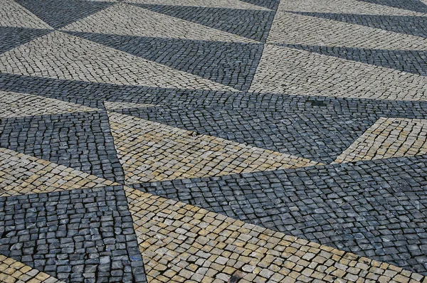 Calcada tradicional de mosaico de piedra portuguesa en Lisboa — Foto de Stock