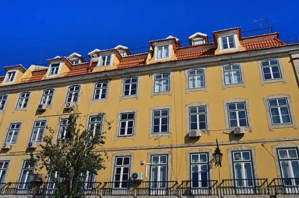 Большой желтый дом с балконами в Лиссабоне — стоковое фото