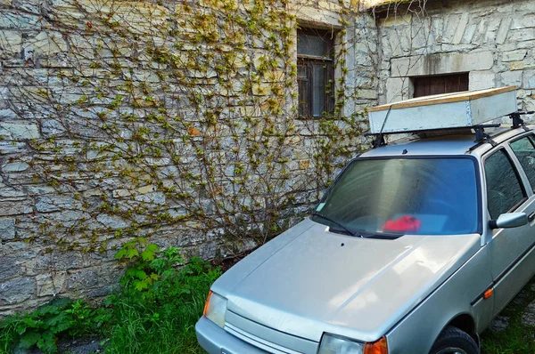 Um carro prateado perto do antigo edifício — Fotografia de Stock