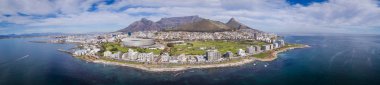 Panoramic aerial view over Cape town in south africa with Greenpoint in the foreground and Table Mountain as a backdrop clipart