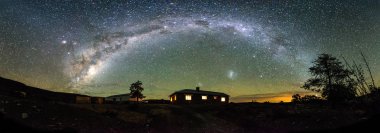 Star trail image over an old abandoned building in the overberg in South Africa clipart