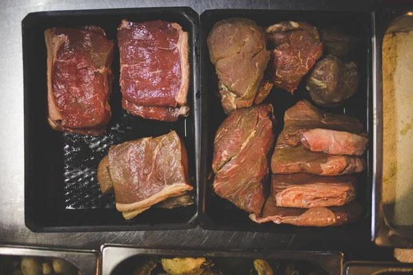 Selection of uncooked steak cuts in a gourmet restaurant ready to be grilled
