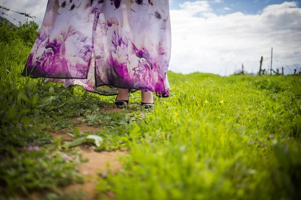 Close up image of a flower print dress blowing softly in the wind