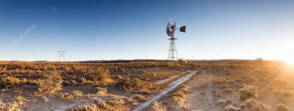 Close up image of a windpump / windmill /windpomp against a bright blue sky in the karoo of south africa 