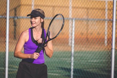 Bir parlak güneş ışığı altında bir kortta tenis oynuyor tenis oyuncu görüntüsünü kapatmak