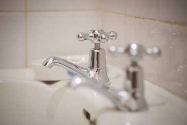 Close up image of  vintage taps in a bathroom clipart