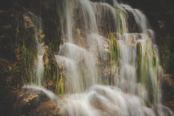 Close up image of a waterfall on rocks captured with a slow shutterspeed