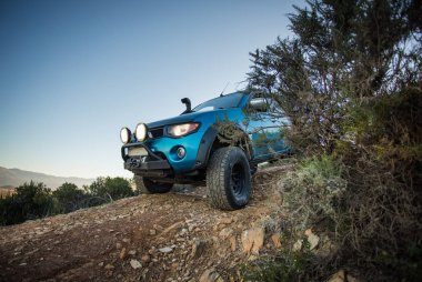 Modifiye edilmiş 4x4 pick up kamyonu almanın geniş açılı görüntüsünü doğada 4x4 pistte kapatın.