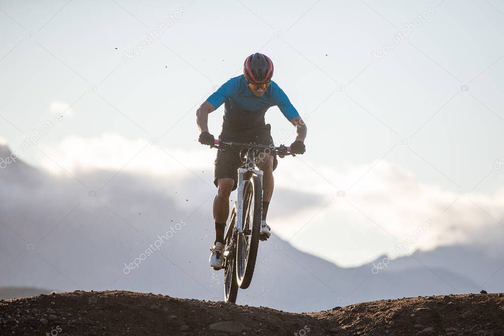 Close up image of a mountain biker speeding downhill on a mountain bike track