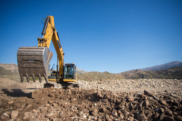 Close up wide angle view of an excavator on a construction site