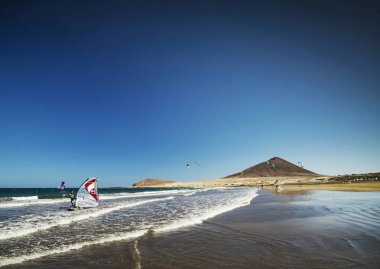 el medano surfing beach and montana roja landmark  in south tenerife spain clipart
