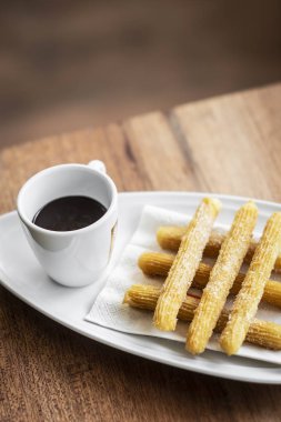 churros con Çikolata geleneksel İspanyol tatlı kahvaltı seti ahşap masa üzerinde
