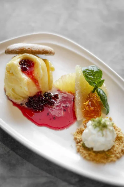 Gourmet mango ice cream with redcurrant sauce dessert on plate — Stock Photo, Image