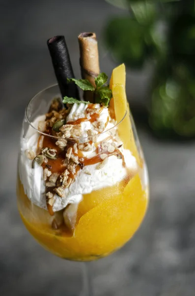 Mango and passion fruit tropical ice cream sundae in glass — Stock Photo, Image